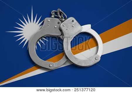 Marshall Islands Flag  And Police Handcuffs. The Concept Of Observance Of The Law In The Country And