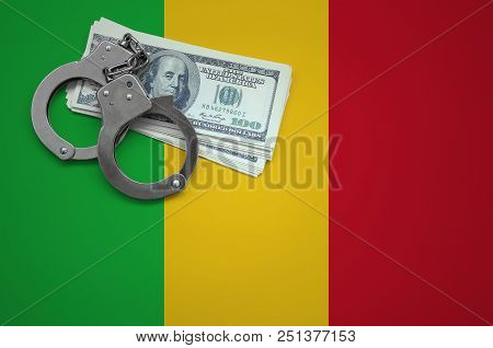 Mali Flag  With Handcuffs And A Bundle Of Dollars. The Concept Of Breaking The Law And Thieves Crime