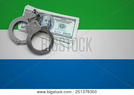 Sierra Leone Flag  With Handcuffs And A Bundle Of Dollars. The Concept Of Breaking The Law And Thiev