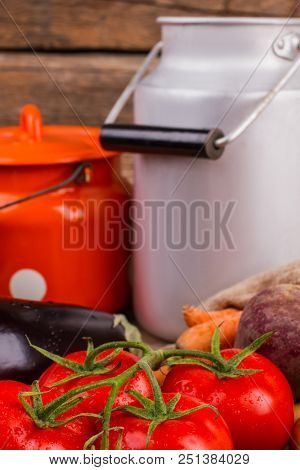 Wet Ripe Tomatoes And Milkchruns. Close Up. Milk Cans.