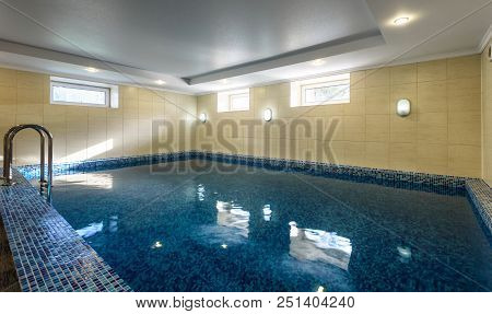 Swimming Pool In Hotel Or Residential House. Modern Pool Interior With Blue Tiles Finish. Large Empt