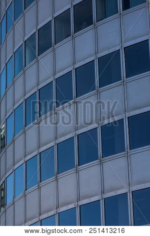 Modern Glass Skycrapers Background With Sky And Clouds Reflection