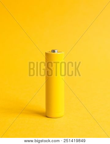 Single Yellow Battery On A Yellow Pastel Background With Crop For Instagram