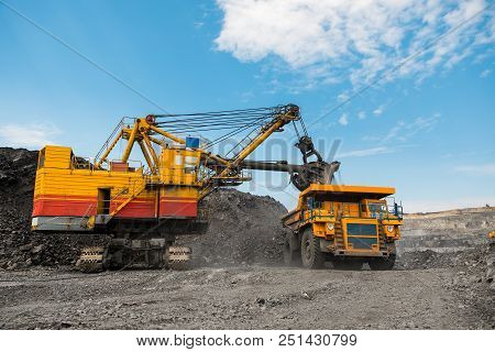 Large Quarry Dump Truck. Loading The Rock In The Dumper. Loading Coal Into Body Work Truck. Mining T