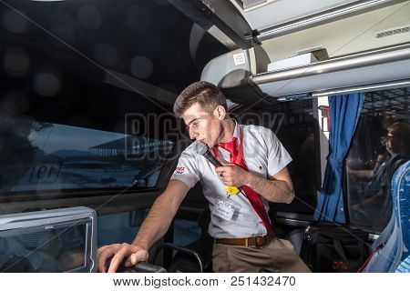 Marmaris, Turkey - May 19, 2018: Male Tour Guide With A Microphone In The Bus In Evening Time