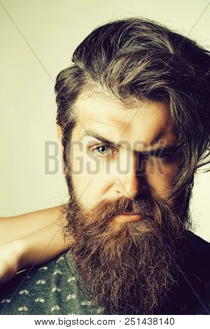Young Man Hipster With Fashion Beard On Serious Handsome Scowl Face With Squinty Eye And Dark Hair P