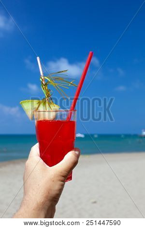 Cocktails On Beach In Male Hand Close-up