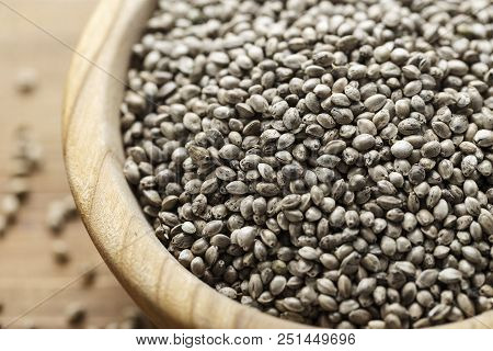 Cannabis Seeds In A Plate, On A Wooden Background, Space For Text
