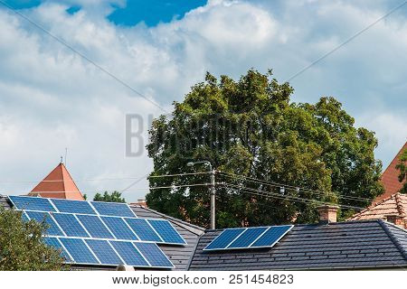 Photovoltaic Panels On Residentual House, Blue Sky Storm Clouds On Background.