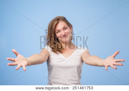 European Woman Raised Up Palms Arms Hands At You, Isolated Over Blue Background. Concept Of Free Fem