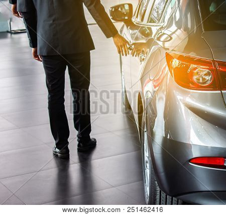 Man Business Saleman Open Door Car On Street Blurry Background.for Automotive Automobile Or Transpor