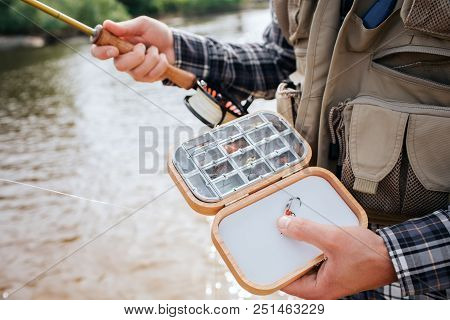 Close Up Of Wooden Box With Diffeent Kind Of Artificial Silicone Fishing Flies And Baits In It. Man 