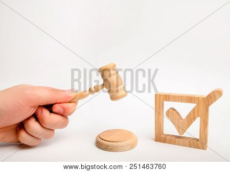 A Wooden Checkmark And A Hammer Of The Judge On A White Background. Appointment Of A Judge, Election