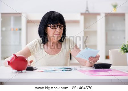 Mature woman trying to reconcile her bills