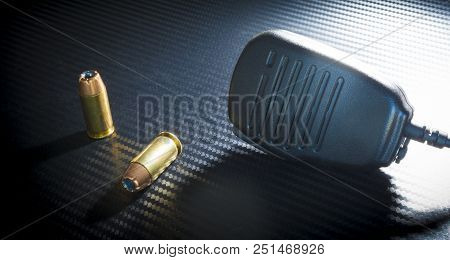 Police Radio Style Microphone And A Pair Of Handgun Bullets