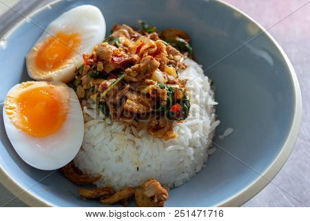 Spicy Fried Rice With Stir Fried Duck With Holy Basil With Boiled Egg And Lime In White Round Plate 