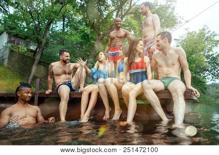 Enjoying Forest Party With Friends. Group Of Beautiful Happy Young Men And Girls Swimming At The Riv