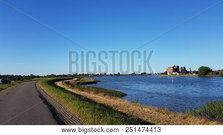 Red Buoys On The Water Of River Hollandsche Ijssel In The Netherlands With Blue Sky.