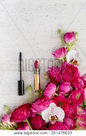 Flowers And Cosmetic Composition -fresh Flowers Of Rununculus And Orchid With Lipstick And Maskara O