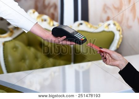 Electronic Finance And Shopping Concept. Credit Card Terminal For Cashless Payments. Cashiers Hand H