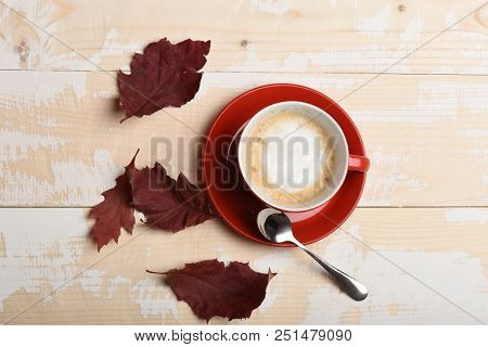 Autumn Coziness Concept. Warm And Cozy Autumn Coffee Time. Red Ceramic Tableware With Tasty Beverage
