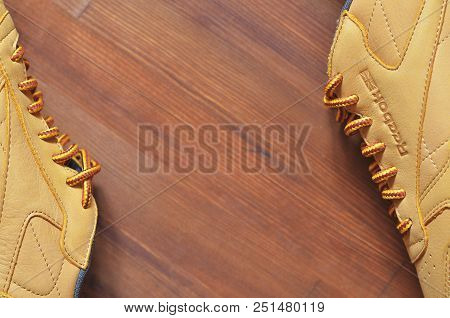 Kiev, Ukraine - May 30, 2018: Reebok Brown Sneakers Lie On The Side On A Dark Wooden Background