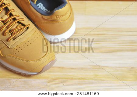 Kiev, Ukraine - May 30, 2018: Reebok Sneakers Stand On The Side Of A Light Wooden Background