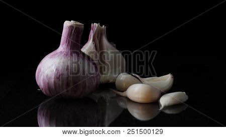 Delicious Beautiful Garlic On Black Background. Frame. Concept Of A Healthy Lifestyle.