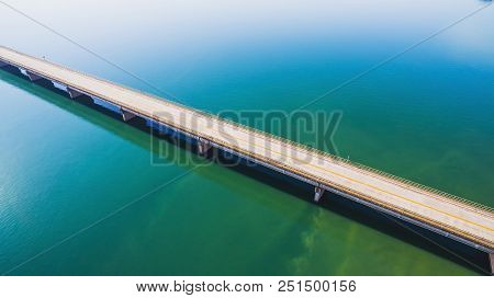 Aerial View Of A Long Highway Bridge Above A River.