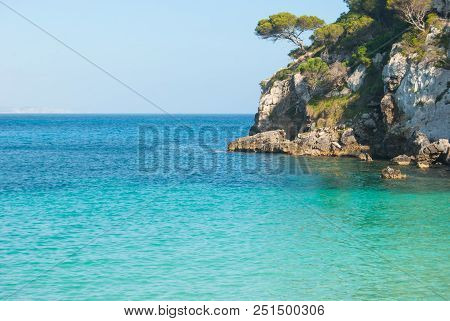 Crystalline Light Blue Sea With Mediterranean Flora Of One Of The Most Famous Little Cove Of Island