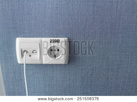 Socket On A Blue Wall, A Multifunction Outlet With An Internet Connection And European-style Outlet
