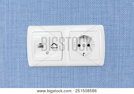 Socket On A Blue Wall, A Multifunction Outlet With An Internet Connection And European-style Outlet