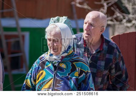 Ukraine, Kamyanets-podilsky - April 11, 2018: Unidentified Old Man And Woman Talking In Fron Of Thei
