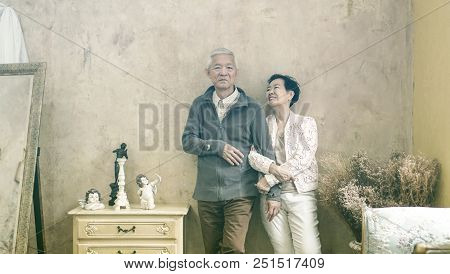 Happy Asian Senior Couple Casual Dress With Sunglasses In Vintage House