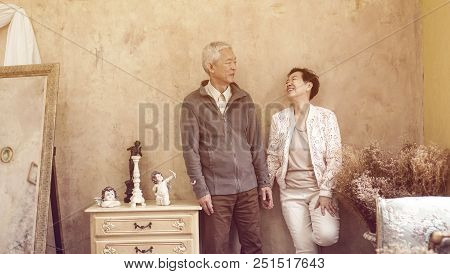 Happy Asian Senior Couple Casual Dress With Sunglasses In Vintage House