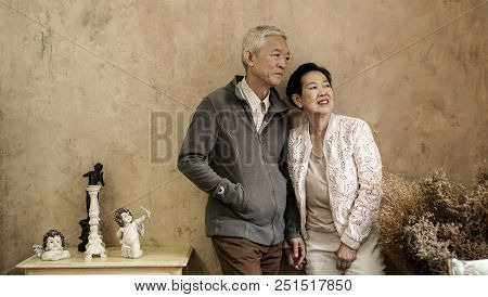 Happy Asian Senior Couple Casual Dress With Sunglasses In Vintage House