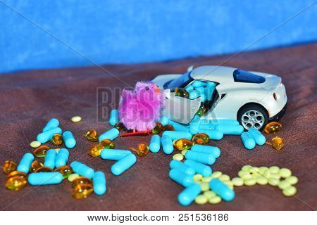 Children's White Typewriter Small Toys, Different Pills On A Brown Surface On A Blue Background. The