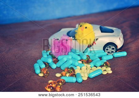 Children's White Typewriter Small Toys, Different Pills On A Brown Surface On A Blue Background. The