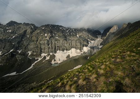 Mountain Landscape Of A Chaukhi Mountain Pass In Georgia. Heavy Clouds Over The Mountain Range.