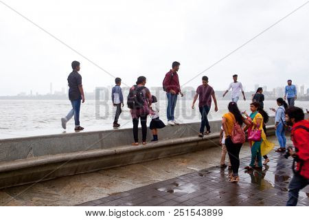 MUMBAI, INDIA - JULY 2 2018: Unidentified people visit promenade in South Mumbai. 
The promenade is an open space where people could meet friends and just spend time