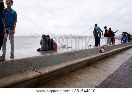MUMBAI, INDIA - JULY 2 2018: Unidentified people visit promenade in South Mumbai. 
The promenade is an open space where people could meet friends and just spend time