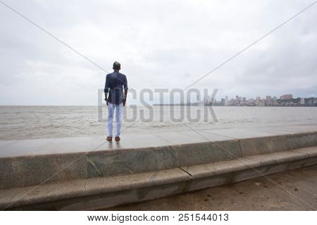 MUMBAI, INDIA - JULY 2 2018: Unidentified people visit promenade in South Mumbai. 
The promenade is an open space where people could meet friends and just spend time