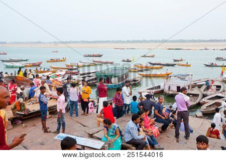 VARANASI, UTTAR PRADESH, INDIA - JULY 6, 2018: Boats with pilgrims arriving at ceremonies Dasashvamedh Ghat 