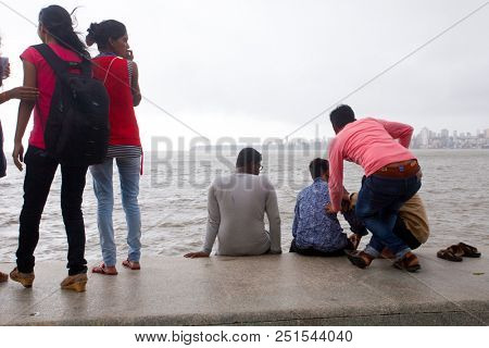 MUMBAI, INDIA - JULY 2 2018: Unidentified people visit promenade in South Mumbai. 
The promenade is an open space where people could meet friends and just spend time
