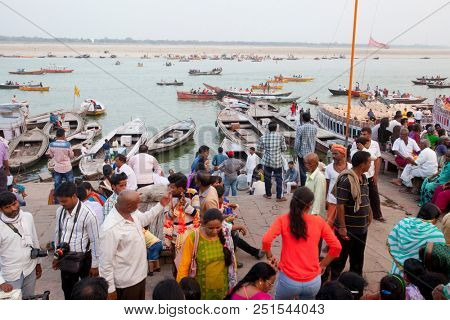 VARANASI, UTTAR PRADESH, INDIA - JULY 6, 2018: Boats with pilgrims arriving at ceremonies Dasashvamedh Ghat 
