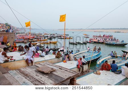 VARANASI, UTTAR PRADESH, INDIA - JULY 6, 2018: Boats with pilgrims arriving at ceremonies Dasashvamedh Ghat 