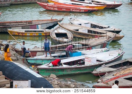 VARANASI, UTTAR PRADESH, INDIA - JULY 6, 2018: Boats with pilgrims arriving at ceremonies Dasashvamedh Ghat 