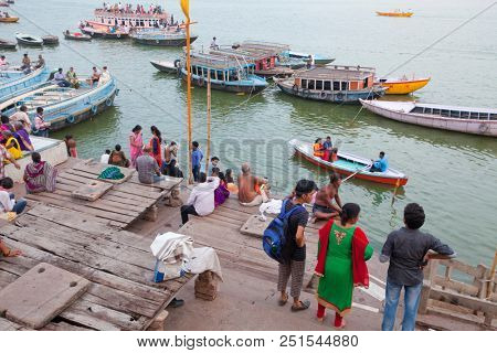 VARANASI, UTTAR PRADESH, INDIA - JULY 6, 2018: Boats with pilgrims arriving at ceremonies Dasashvamedh Ghat 