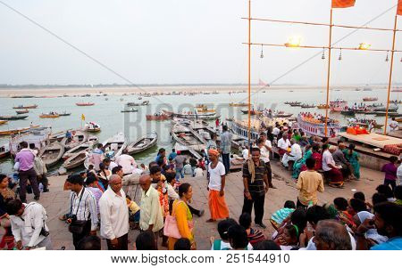 VARANASI, UTTAR PRADESH, INDIA - JULY 6, 2018: Boats with pilgrims arriving at ceremonies Dasashvamedh Ghat 