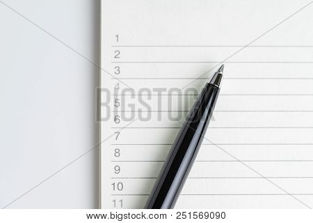 Close-up Of Pen On Empty Note Paper Sheet, White Note Pad With Number Listed Priority Or To Do Tasks